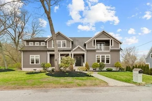 a front view of a house with garage and green space