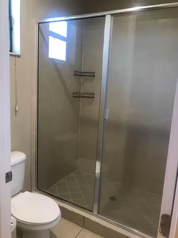 a white bath tub sitting next to a bathroom sink