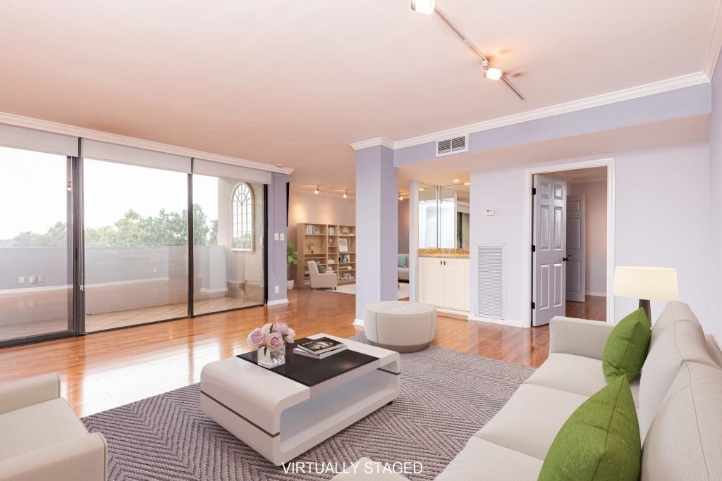 a living room with furniture and a floor to ceiling window