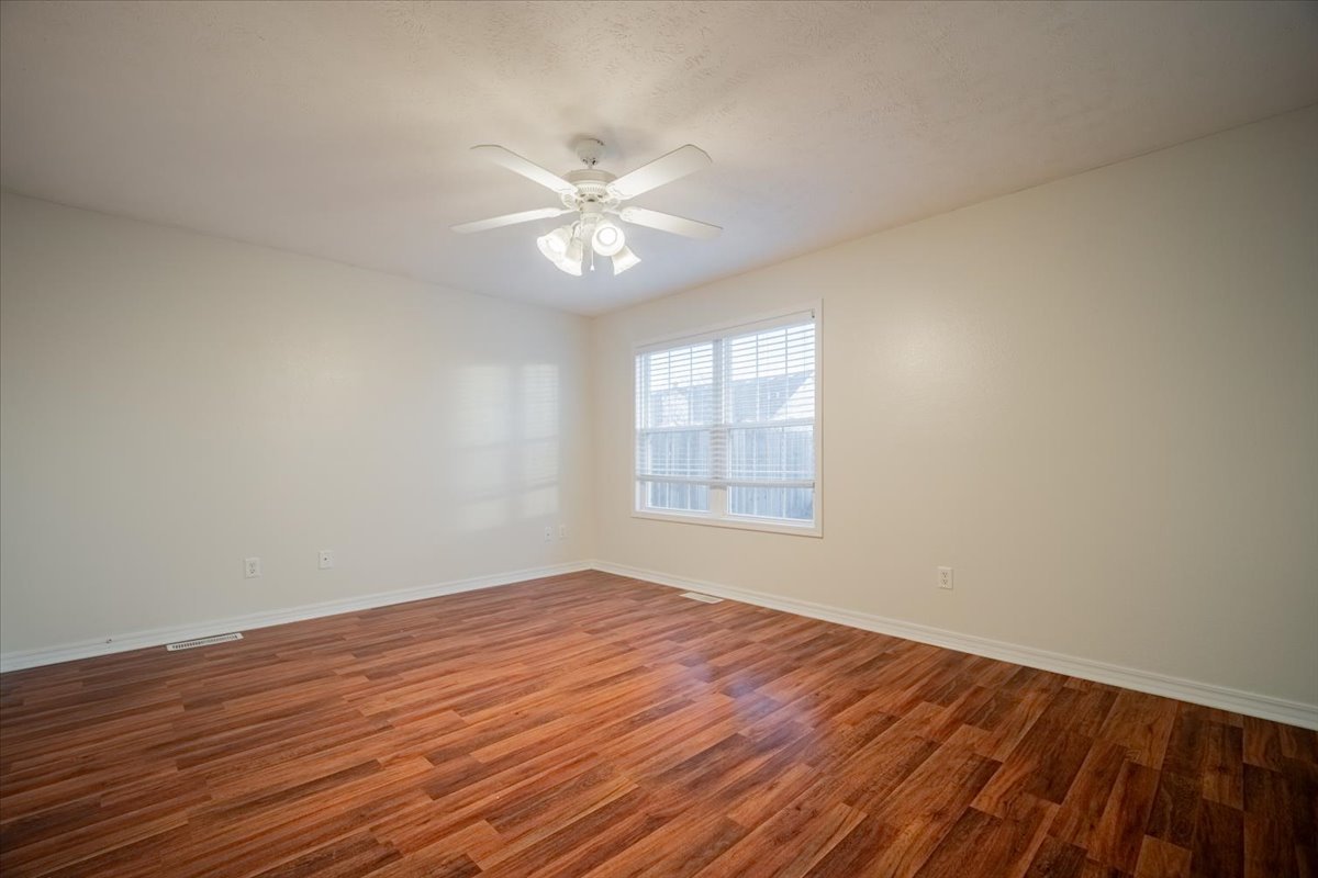 2885 East Raab Road Normal, IL 61761 - Photo 12 of 35 a view of an empty room with wooden floor and a window