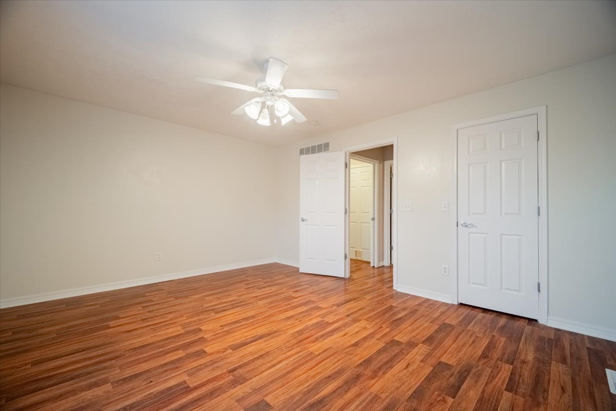 2885 East Raab Road Normal, IL 61761 - Photo 13 of 35 an empty room with wooden floor and ceiling fan