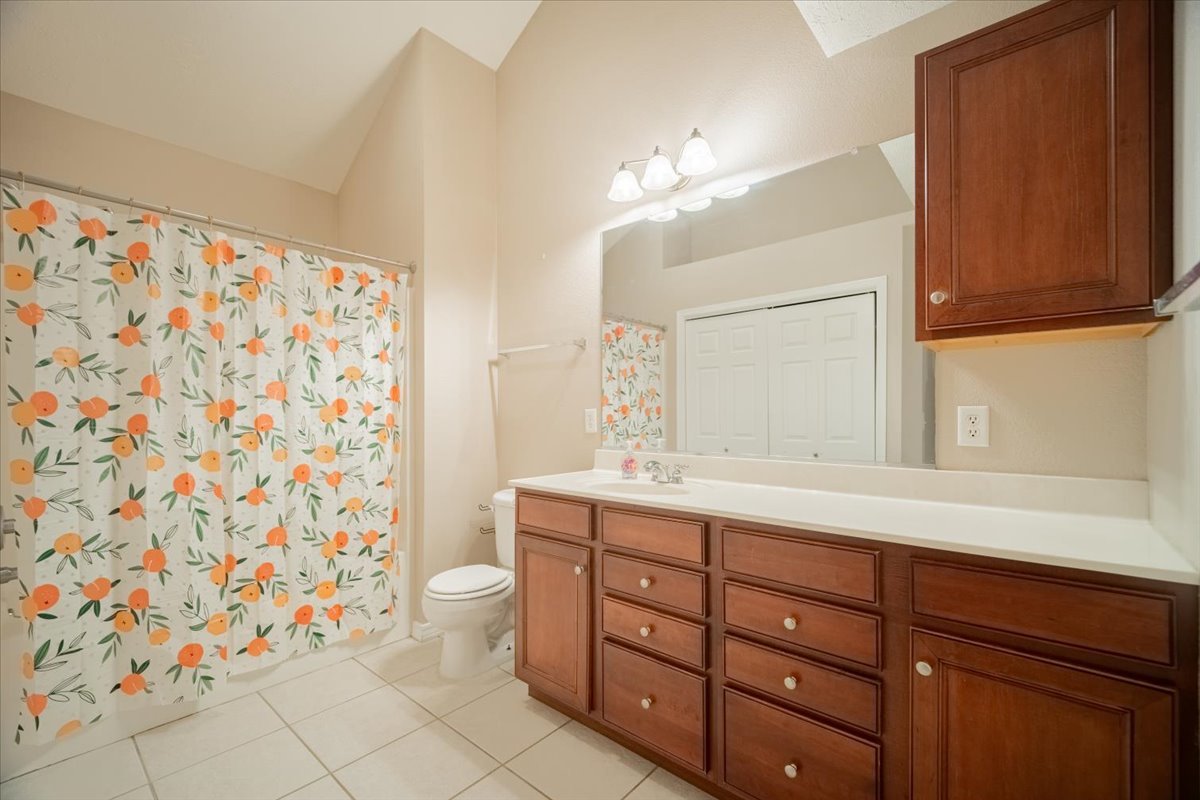 2885 East Raab Road Normal, IL 61761 - Photo 14 of 35 a bathroom with a double vanity sink mirror and toilet