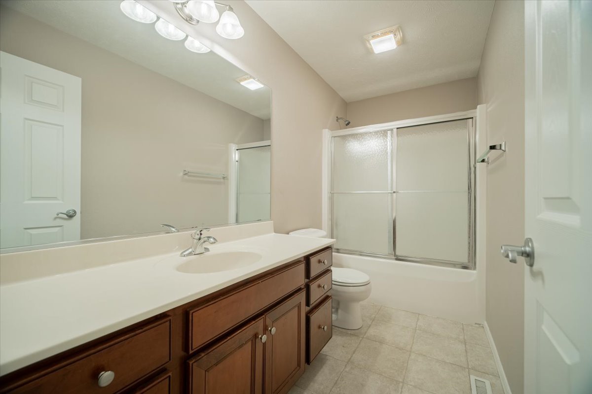2885 East Raab Road Normal, IL 61761 - Photo 19 of 35 a bathroom with a sink a toilet and shower
