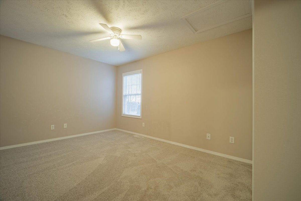2885 East Raab Road Normal, IL 61761 - Photo 20 of 35 an empty room with a chandelier fan and windows