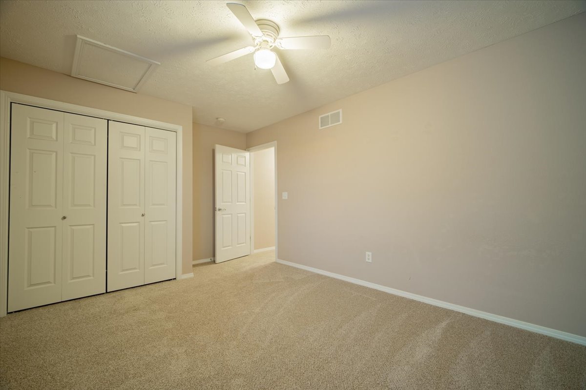 2885 East Raab Road Normal, IL 61761 - Photo 21 of 35 an empty room with a ceiling fan and a fan