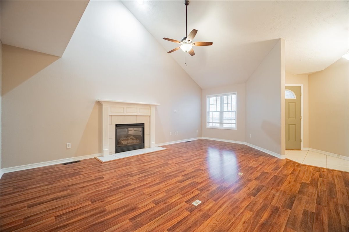 2885 East Raab Road Normal, IL 61761 - Photo 6 of 35 a view of empty room with wooden floor and fan