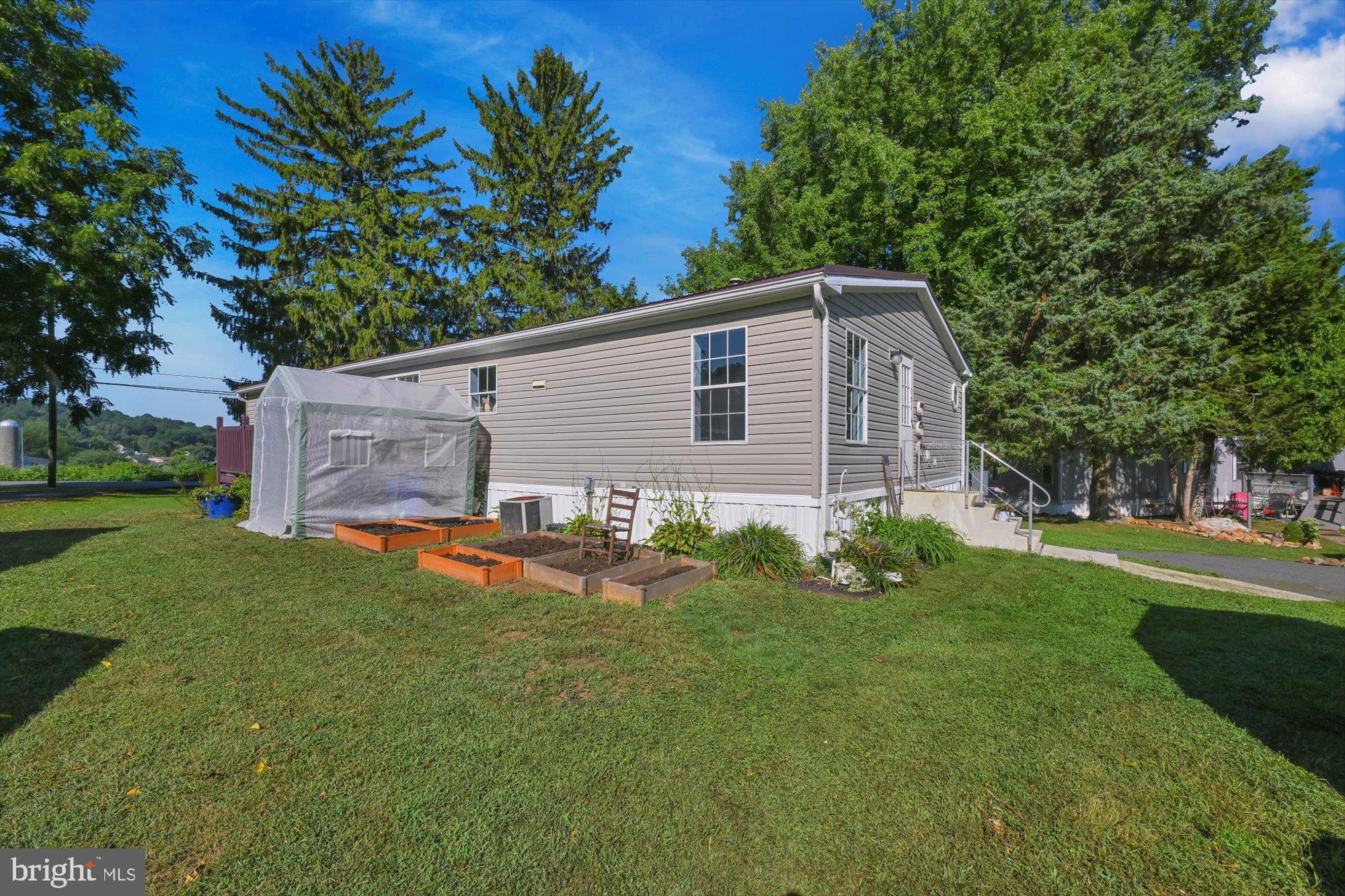789 Hoffmeier Road Gap, PA 17527 - Photo 2 of 26 a backyard of a house with table and chairs plants and large tree