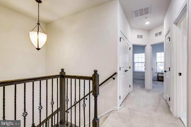 823 Orchard Tree Road, Unit 49 Odenton, MD 21113 - Photo 12 of 28 Upstairs Hallway w/ Custom Railing & Wrought Iron