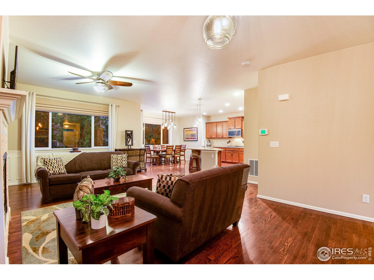5762 Graphite Street Timnath, CO 80547 - Photo 10 of 27 a living room with furniture a chandelier and a dining room