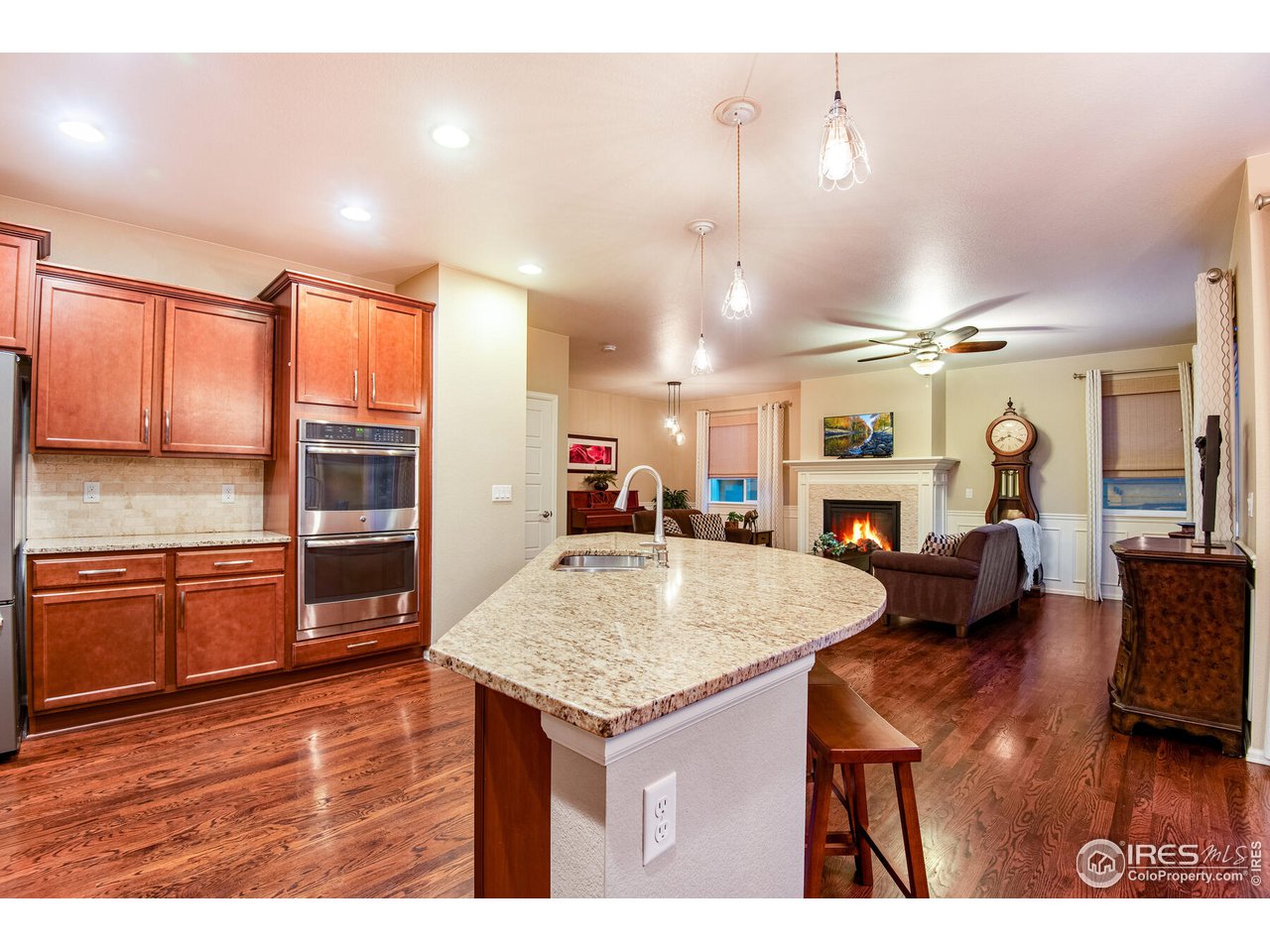 5762 Graphite Street Timnath, CO 80547 - Photo 13 of 27 a kitchen with stainless steel appliances granite countertop a kitchen island a stove and a sink