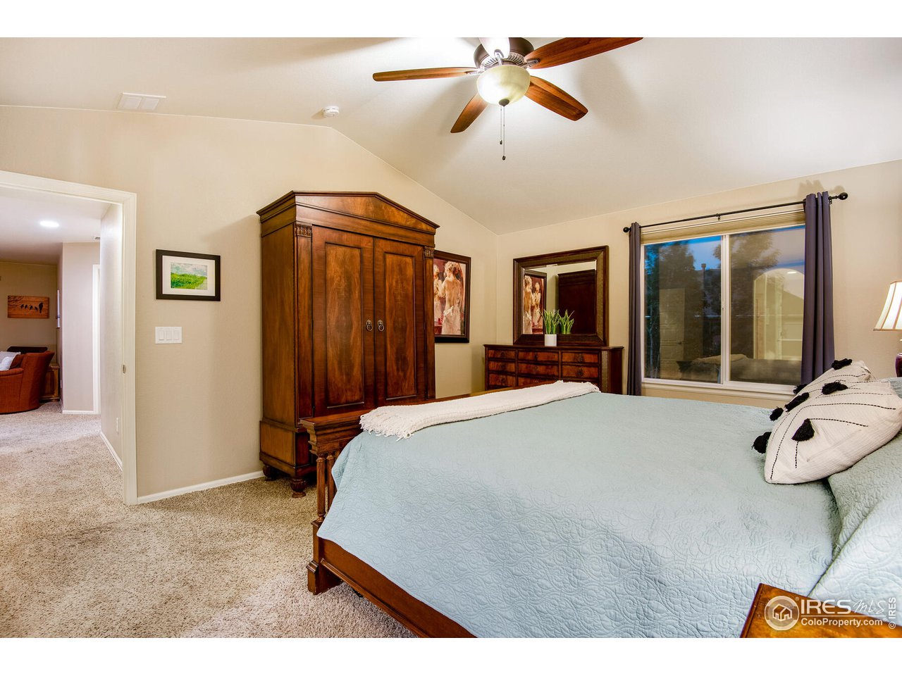 5762 Graphite Street Timnath, CO 80547 - Photo 21 of 27 a bed room with a bed mirror and a chandelier