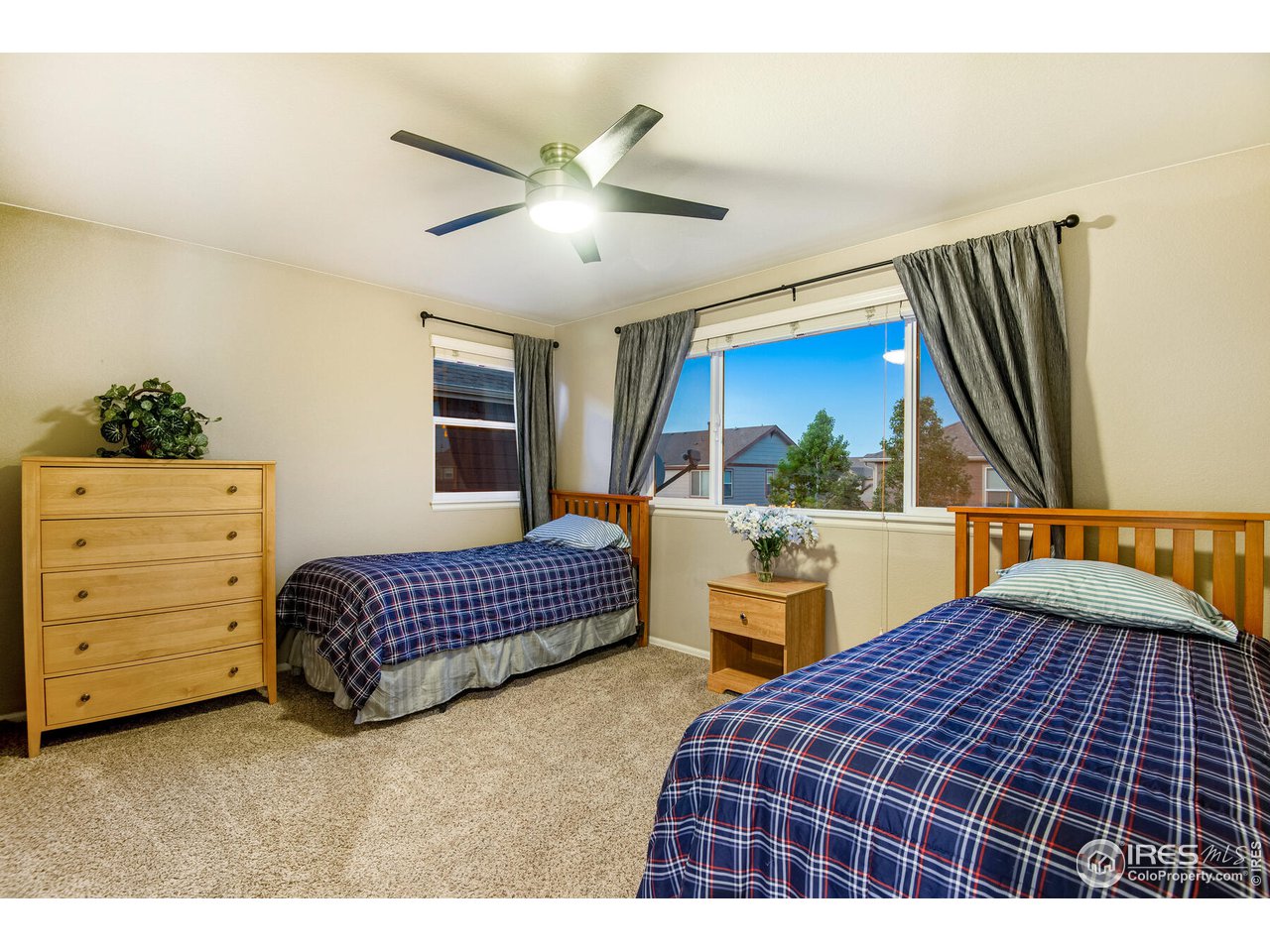 5762 Graphite Street Timnath, CO 80547 - Photo 24 of 27 a bedroom with a large bed and a window
