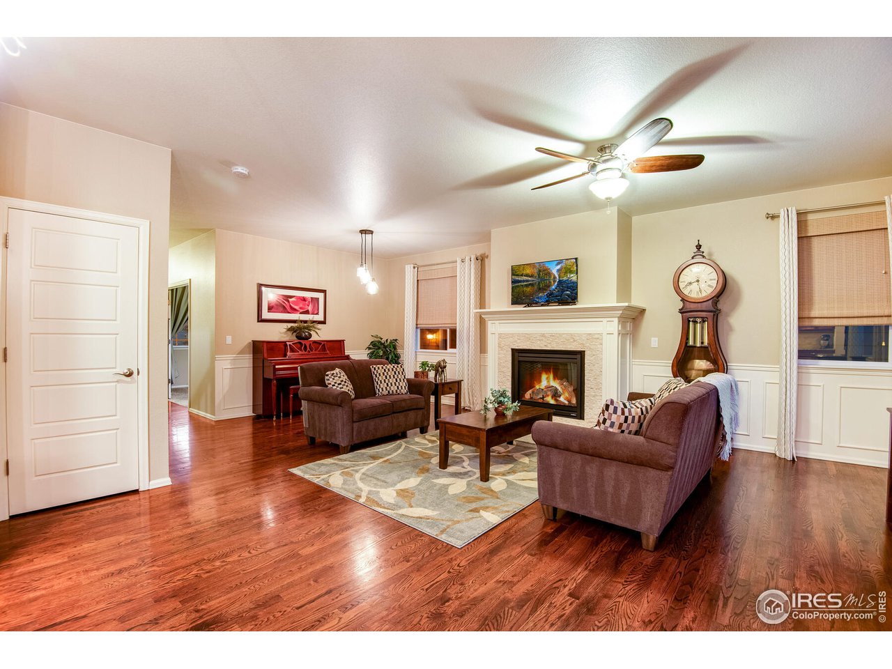 5762 Graphite Street Timnath, CO 80547 - Photo 8 of 27 a living room with furniture fireplace and wooden floor