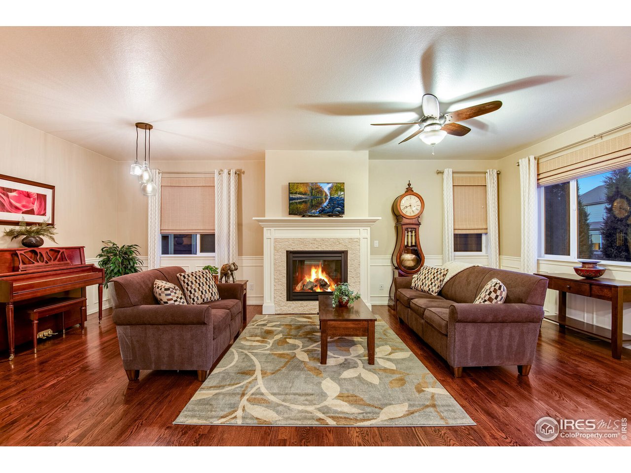 5762 Graphite Street Timnath, CO 80547 - Photo 9 of 27 a living room with furniture and a fireplace