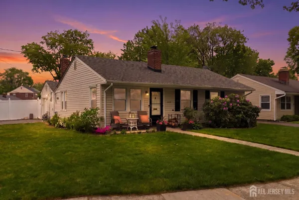 a front view of a house with a garden and porch