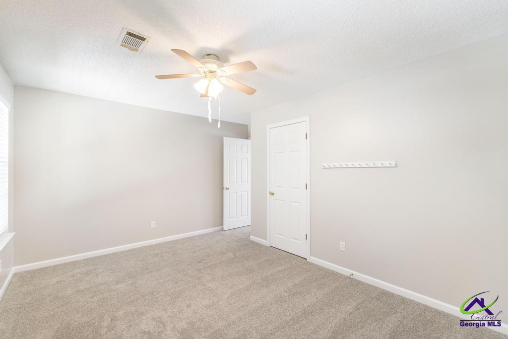 110 Arbor Climb Road Macon, GA 31210 - Photo 31 of 42 an empty room with a window and a fan