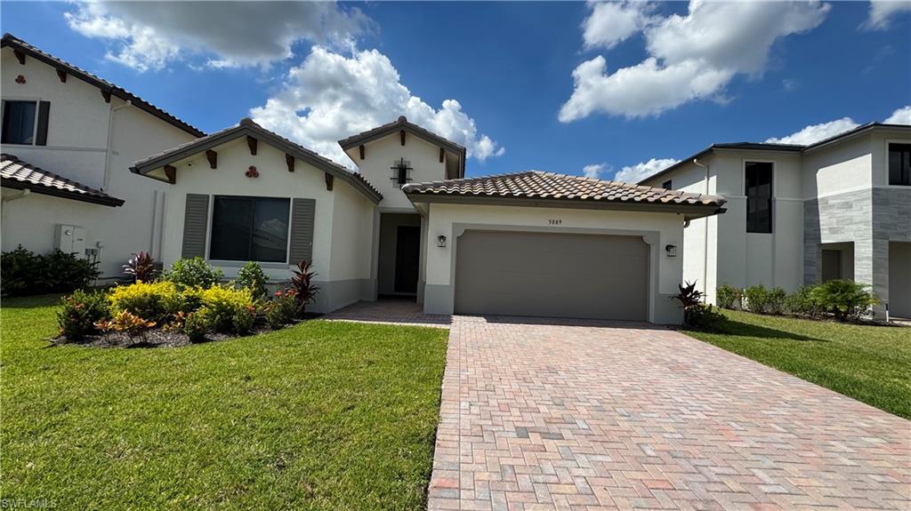 5097 Panella Avenue Ave Maria, FL 34142 - Photo 1 of 48 a front view of a house with garden