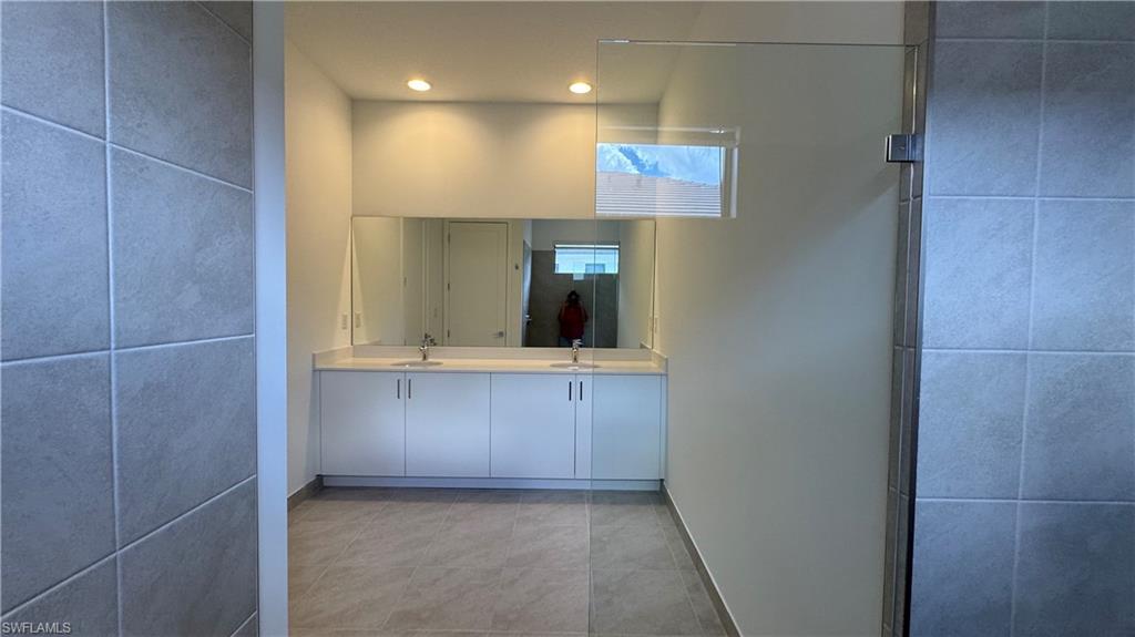 5097 Panella Avenue Ave Maria, FL 34142 - Photo 7 of 48 a bathroom with a sink and mirror