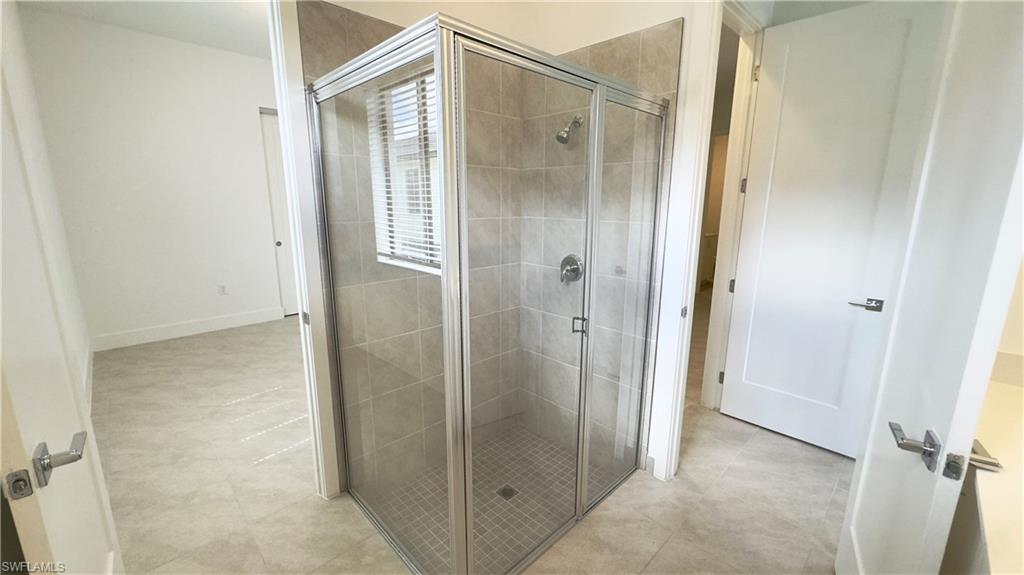 5097 Panella Avenue Ave Maria, FL 34142 - Photo 11 of 48 a bathroom with a shower and a glass door