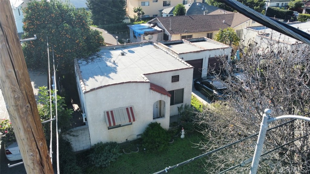 an aerial view of a house with yard and patio