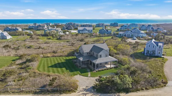 an aerial view of a house with a yard