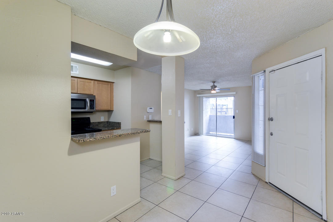 4410 North Longview Avenue, Unit 106 Phoenix, AZ 85014 - Photo 11 of 25 a view of a kitchen with a sink and a refrigerator
