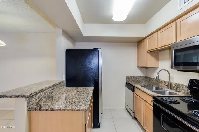a bathroom with a granite countertop sink vanity and mirror