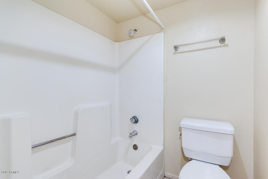 4410 North Longview Avenue, Unit 106 Phoenix, AZ 85014 - Photo 22 of 25 a white toilet sitting next to a bathroom sink