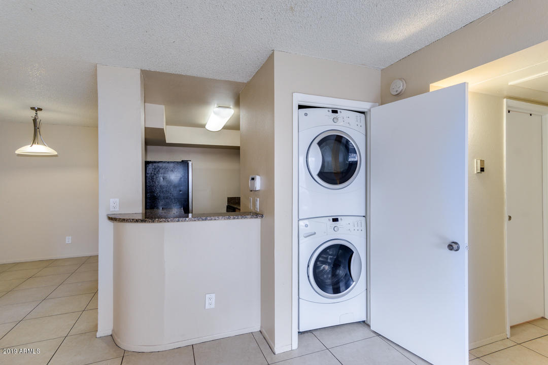 4410 North Longview Avenue, Unit 106 Phoenix, AZ 85014 - Photo 23 of 25 a view of a hallway with washer and dryer