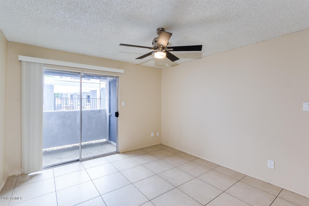 4410 North Longview Avenue, Unit 106 Phoenix, AZ 85014 - Photo 9 of 25 a view of an empty room and window a ceiling fan