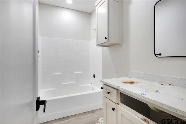 a bathroom with a bathtub and a sink