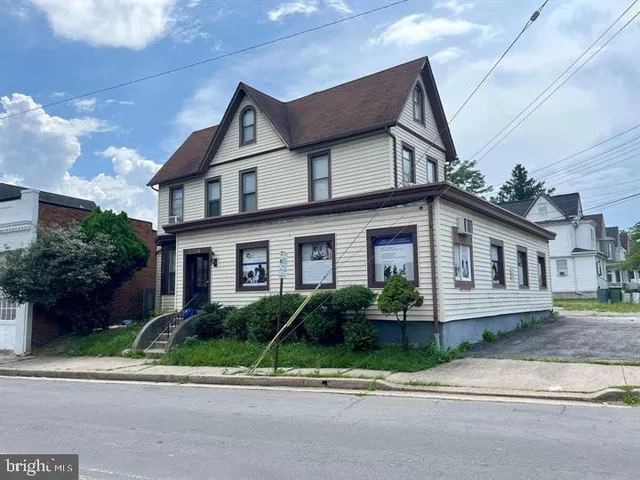 a house that has a tree in front of it