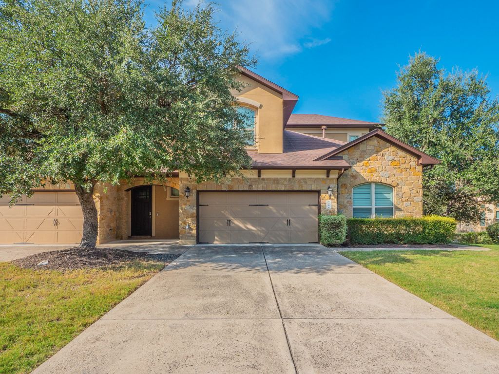 826 San Remo Boulevard Lakeway, TX 78734 - Photo 1 of 25 a front view of a house with a garden