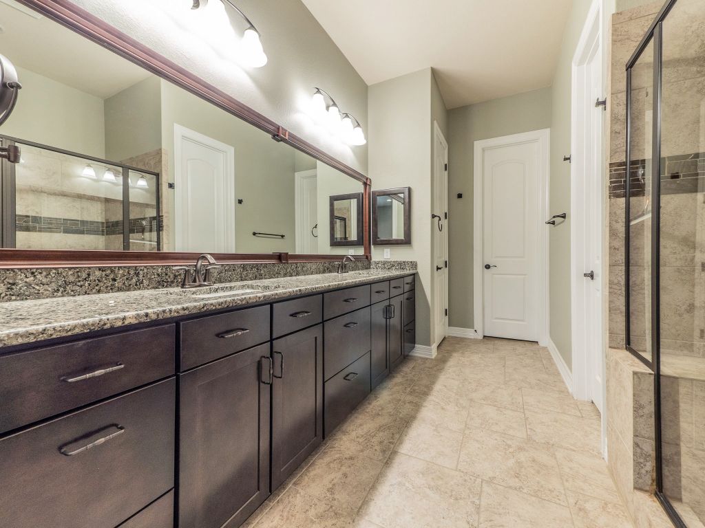826 San Remo Boulevard Lakeway, TX 78734 - Photo 12 of 25 a spacious bathroom with a granite countertop sink mirror and double