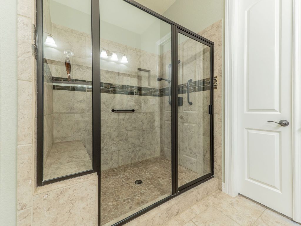 826 San Remo Boulevard Lakeway, TX 78734 - Photo 13 of 25 a bathroom with a glass shower door