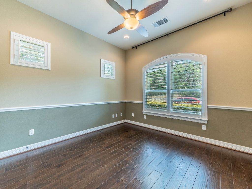 826 San Remo Boulevard Lakeway, TX 78734 - Photo 14 of 25 an empty room with wooden floor and windows