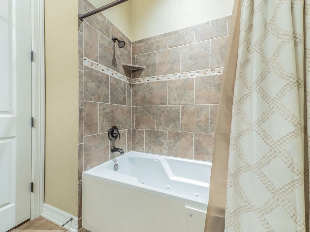 826 San Remo Boulevard Lakeway, TX 78734 - Photo 16 of 25 a bathroom with a sink a toilet and shower