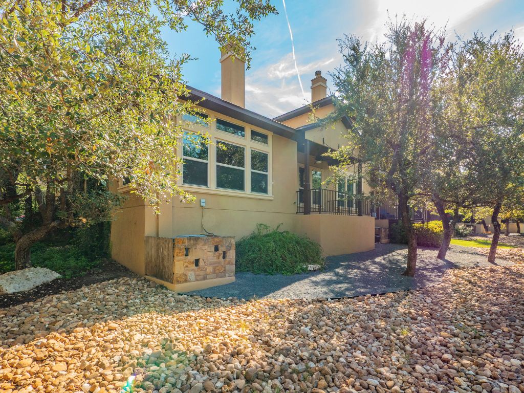 826 San Remo Boulevard Lakeway, TX 78734 - Photo 24 of 25 a front view of a house with a yard