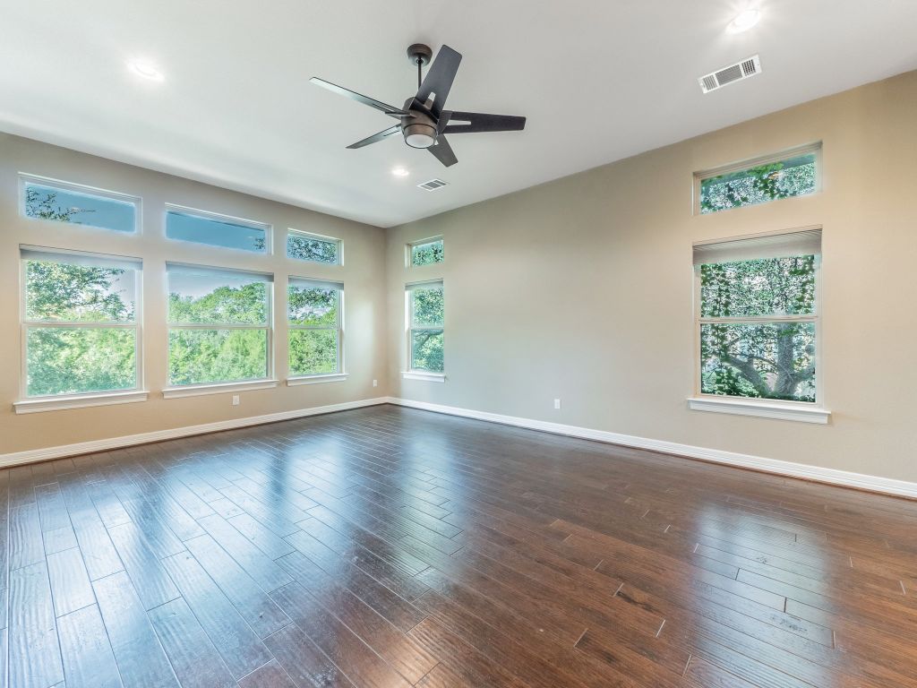 826 San Remo Boulevard Lakeway, TX 78734 - Photo 4 of 25 a view of a livingroom with wooden floor window and a ceiling fan
