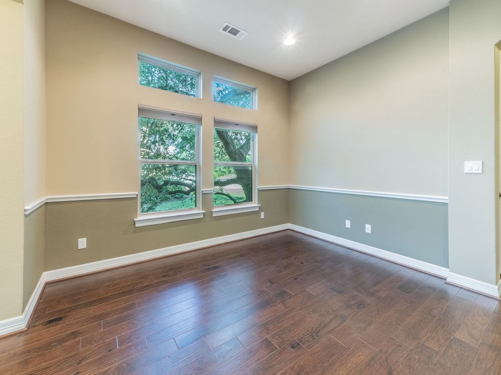 826 San Remo Boulevard Lakeway, TX 78734 - Photo 8 of 25 an empty room with wooden floor and windows
