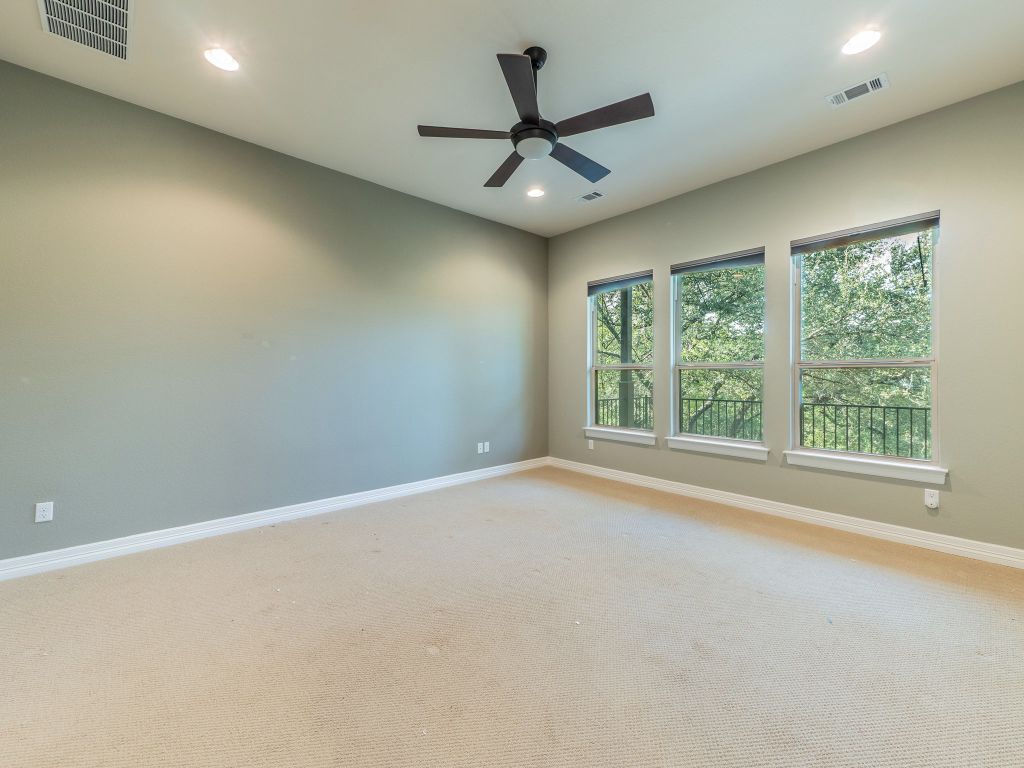 826 San Remo Boulevard Lakeway, TX 78734 - Photo 9 of 25 an empty room with a ceiling fan and window