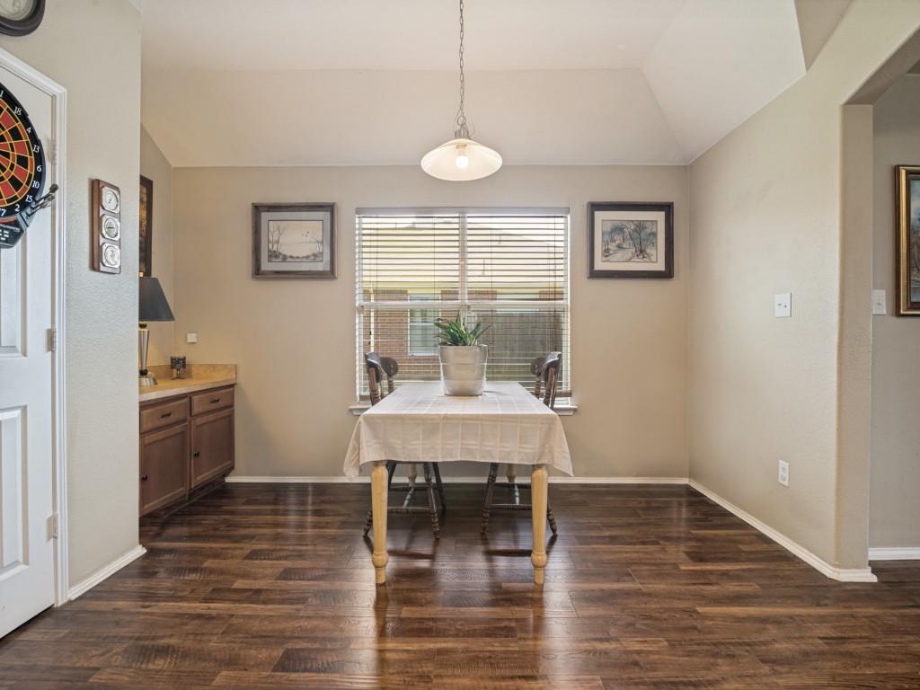 119 Robin Lane Forney, TX 75126 - Photo 12 of 27 Dining area featuring wood-finish flooring, a window with horizontal blinds, and a built-in cabinet with a countertop