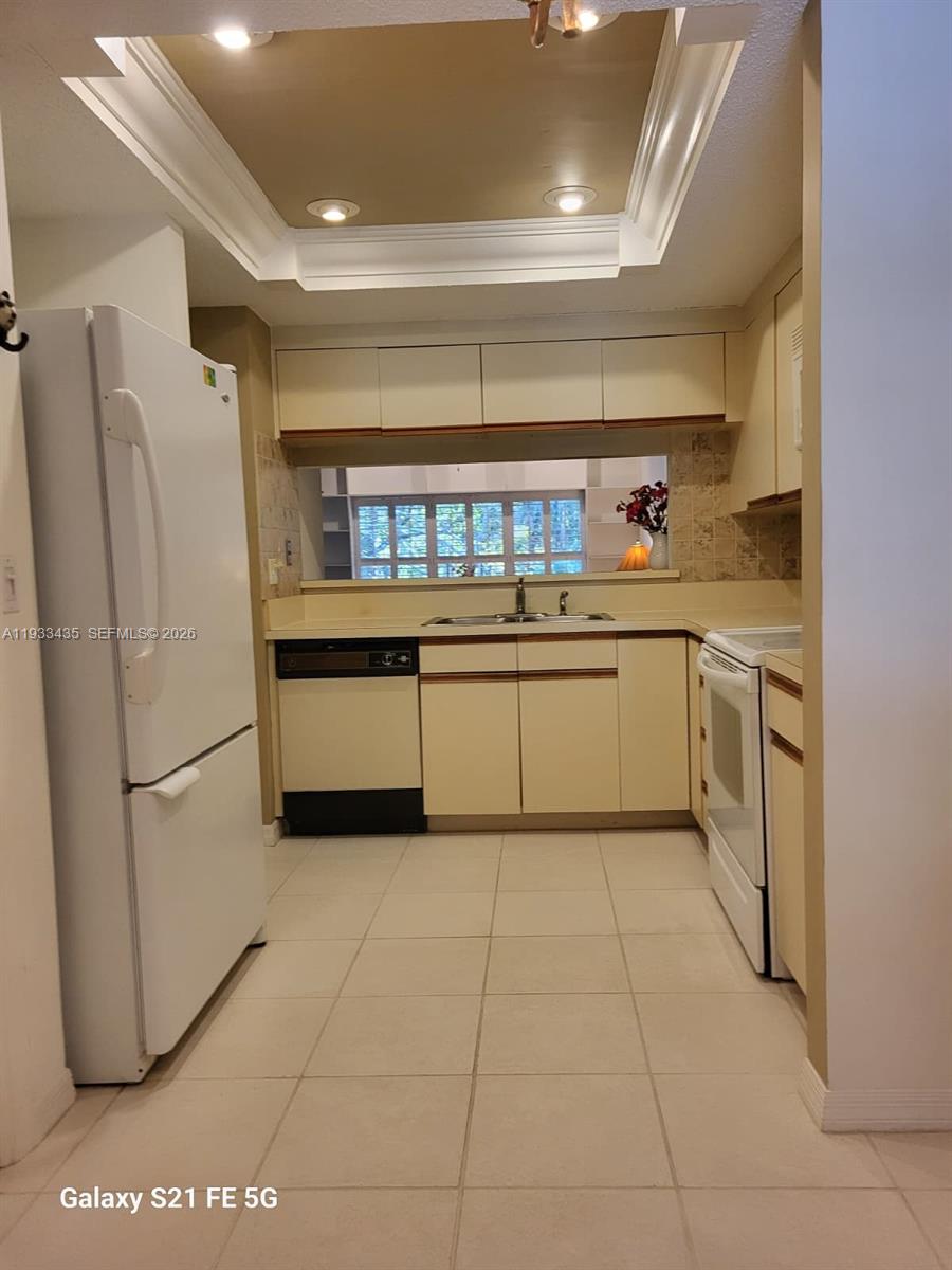 5200 Southeast Seascape Way, Unit 201 Stuart, FL 34997 - Photo 12 of 33 a kitchen with stainless steel appliances a refrigerator and a sink