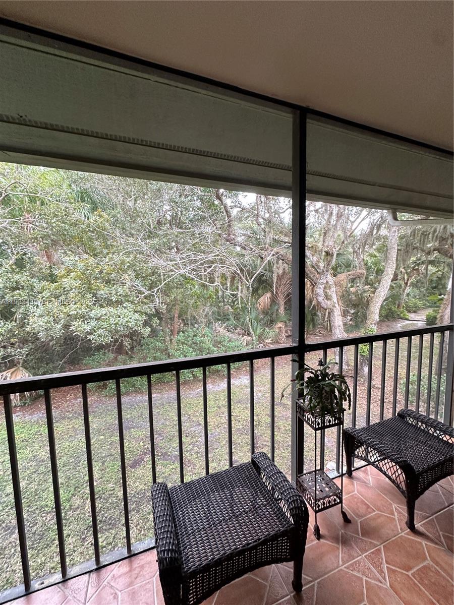 5200 Southeast Seascape Way, Unit 201 Stuart, FL 34997 - Photo 18 of 33 a balcony with wooden floor in outdoor space