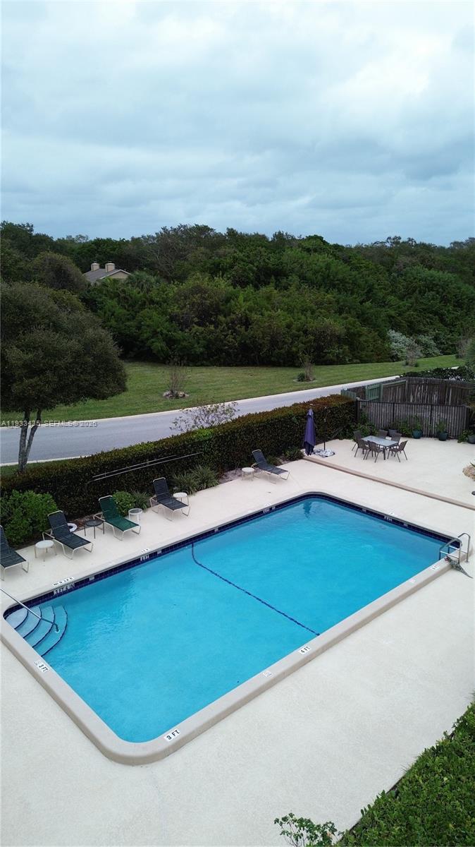 5200 Southeast Seascape Way, Unit 201 Stuart, FL 34997 - Photo 21 of 33 a view of a swimming pool with a terrace