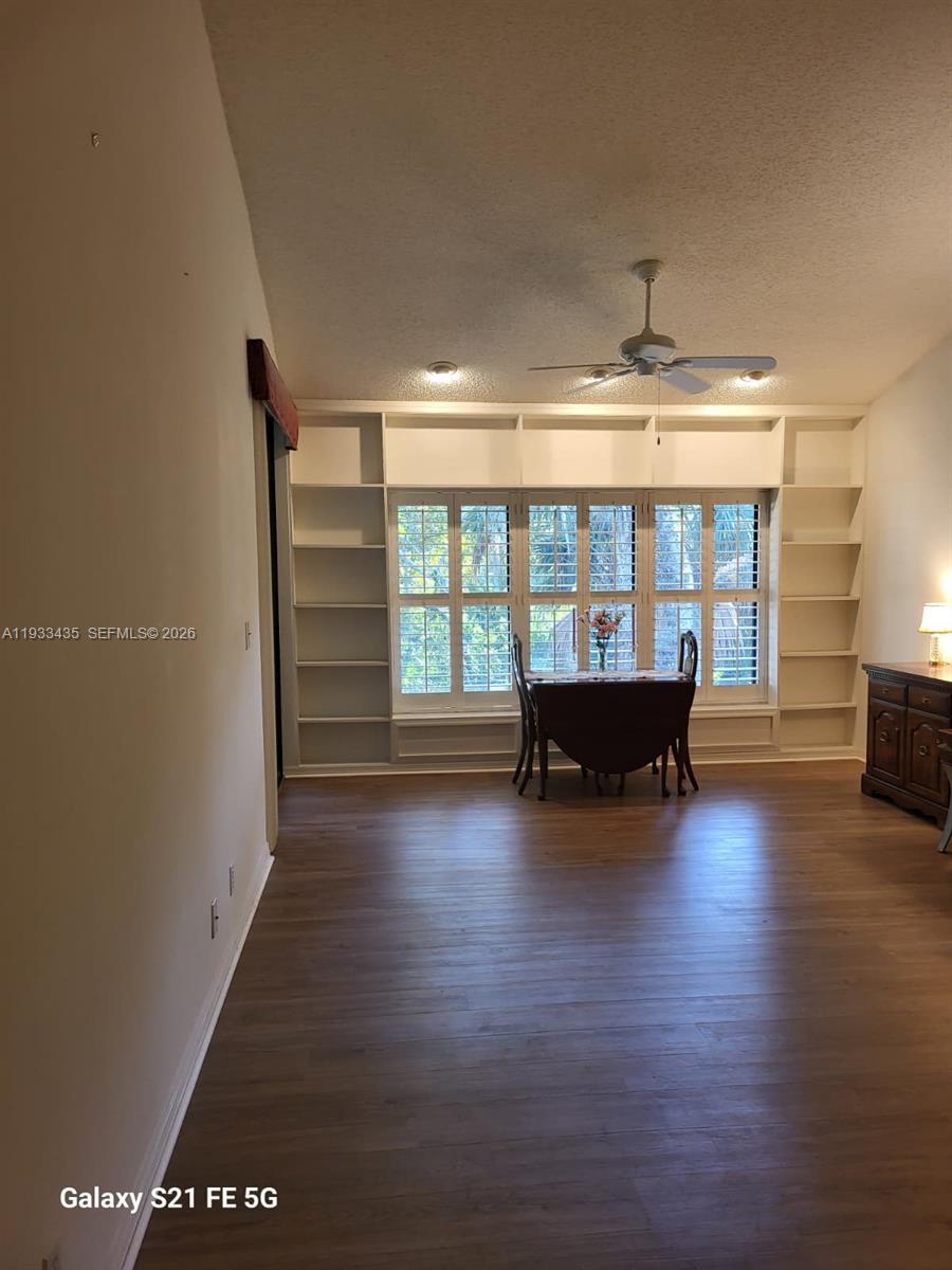 5200 Southeast Seascape Way, Unit 201 Stuart, FL 34997 - Photo 5 of 33 an empty room with wooden floor and fireplace