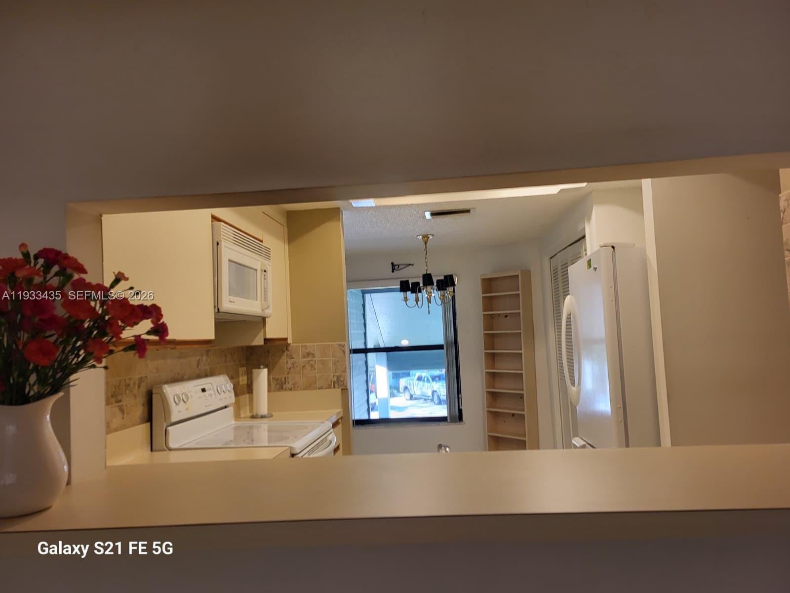 5200 Southeast Seascape Way, Unit 201 Stuart, FL 34997 - Photo 6 of 33 a living room with furniture and a window