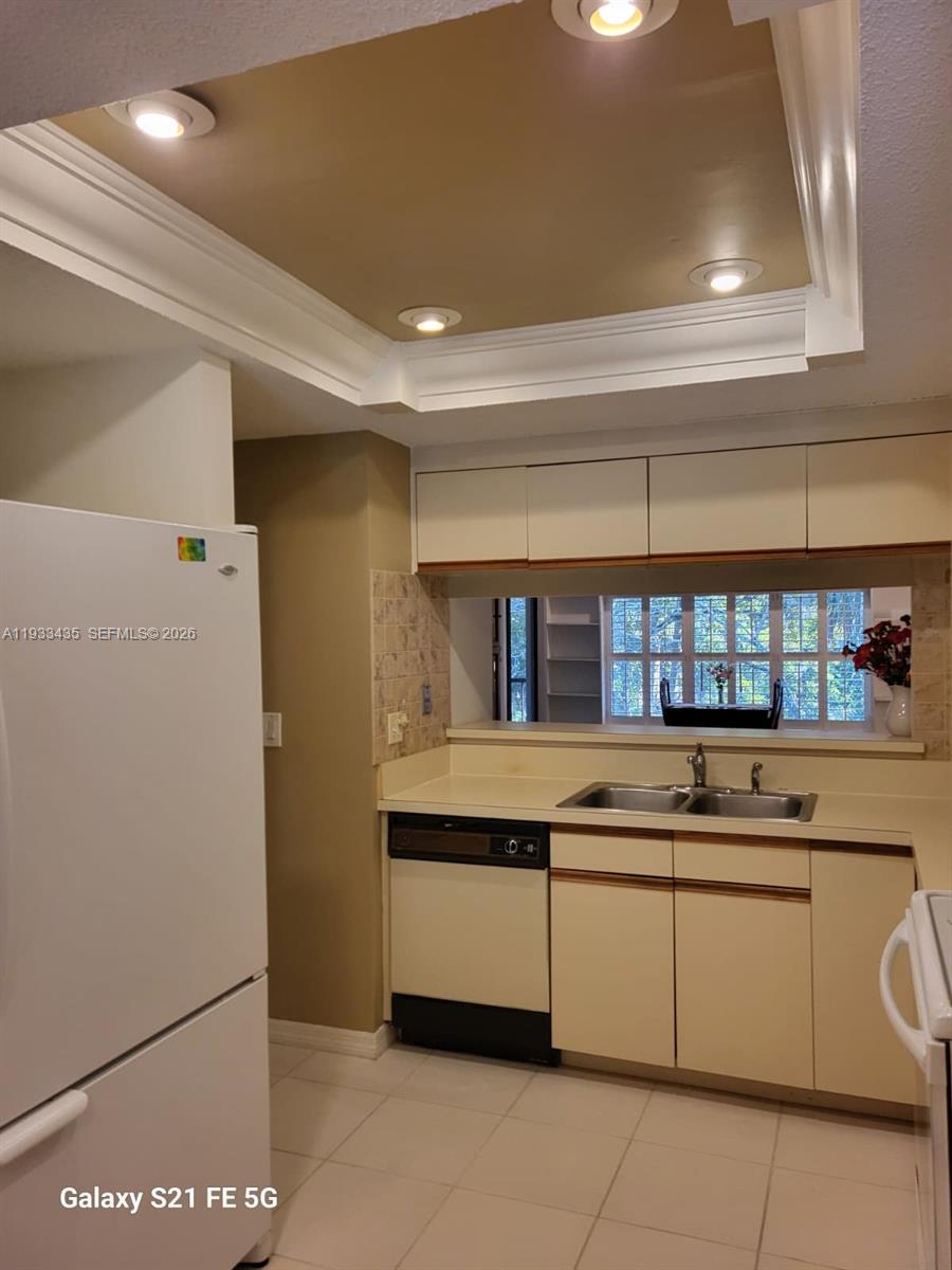 5200 Southeast Seascape Way, Unit 201 Stuart, FL 34997 - Photo 9 of 33 a kitchen with a sink and cabinets