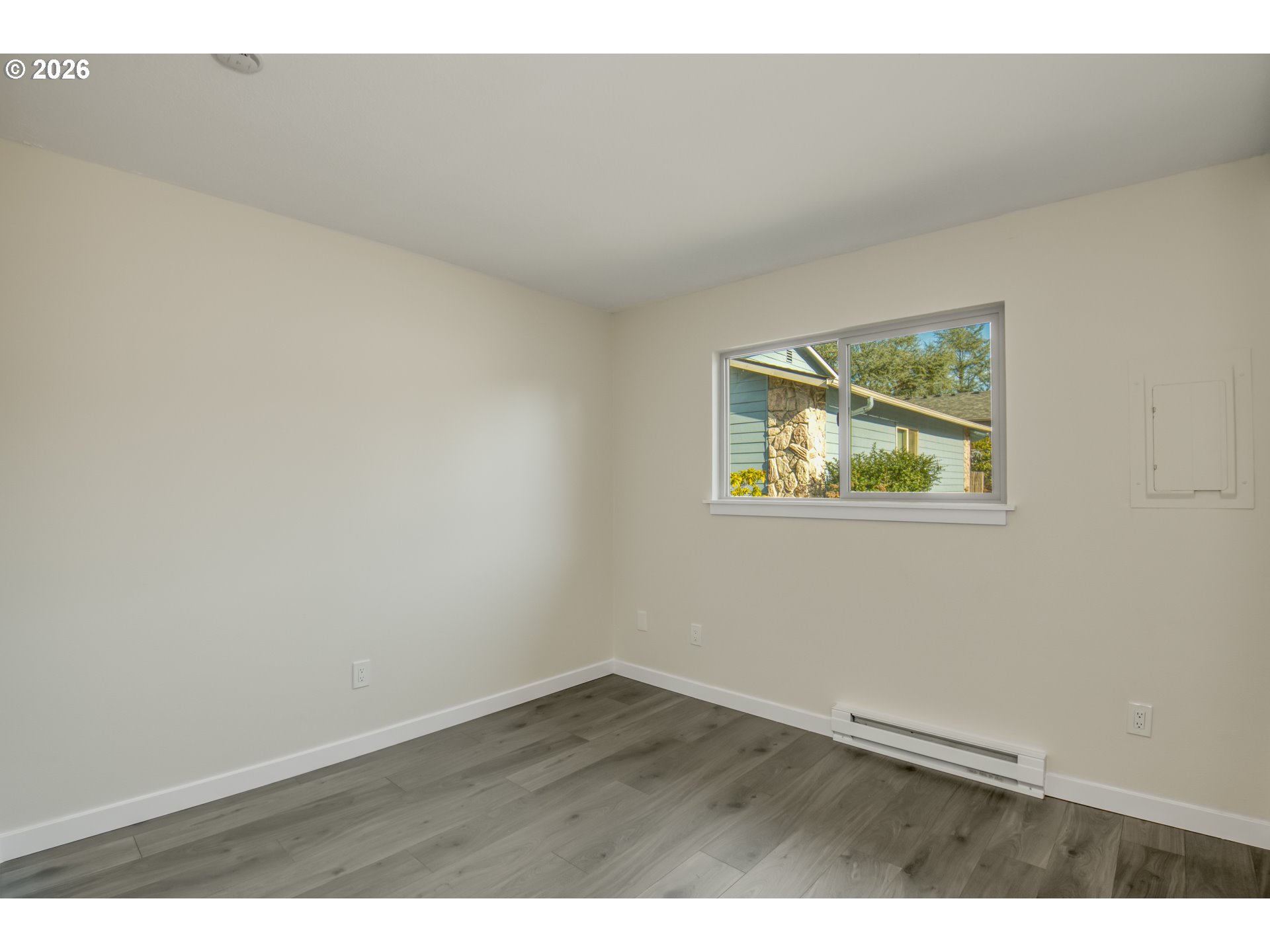 3114 Southwest Carson Street Portland, OR 97219 - Photo 13 of 18 a view of an empty room with wooden floor and a window