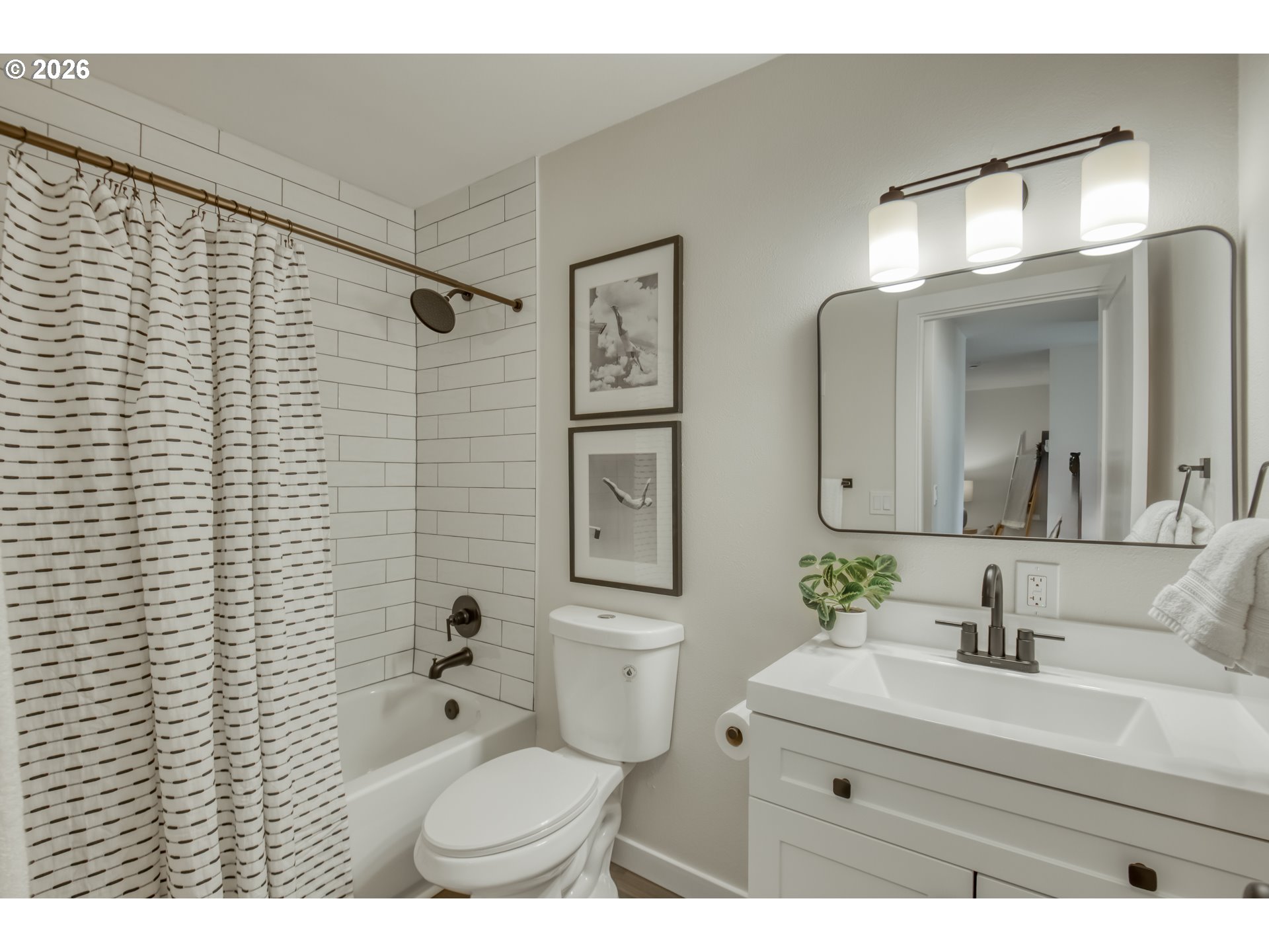3114 Southwest Carson Street Portland, OR 97219 - Photo 15 of 18 a bathroom with a toilet a sink a mirror and a shower